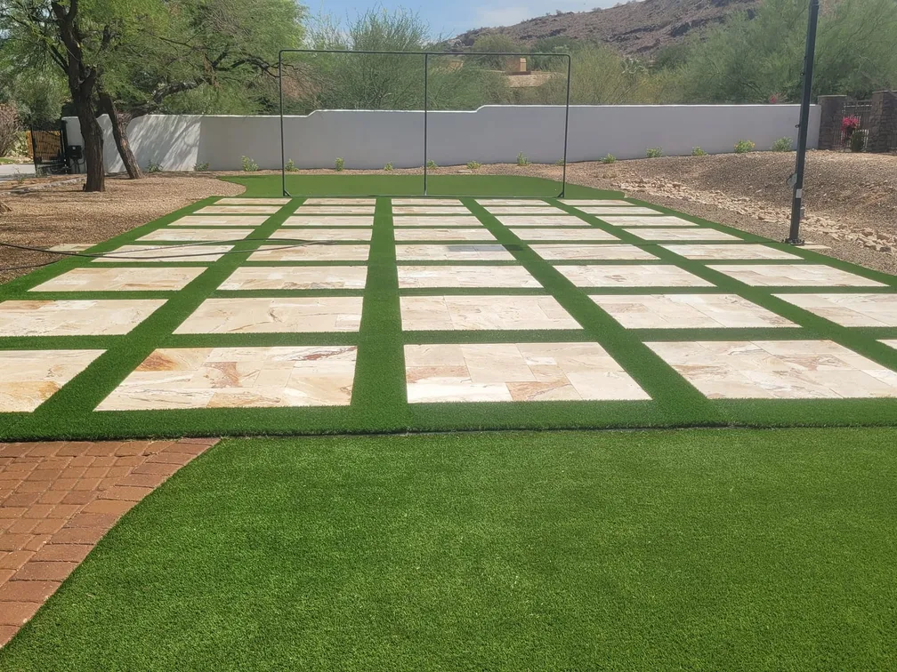 Artificial turf with square paver pads, the mountains behind