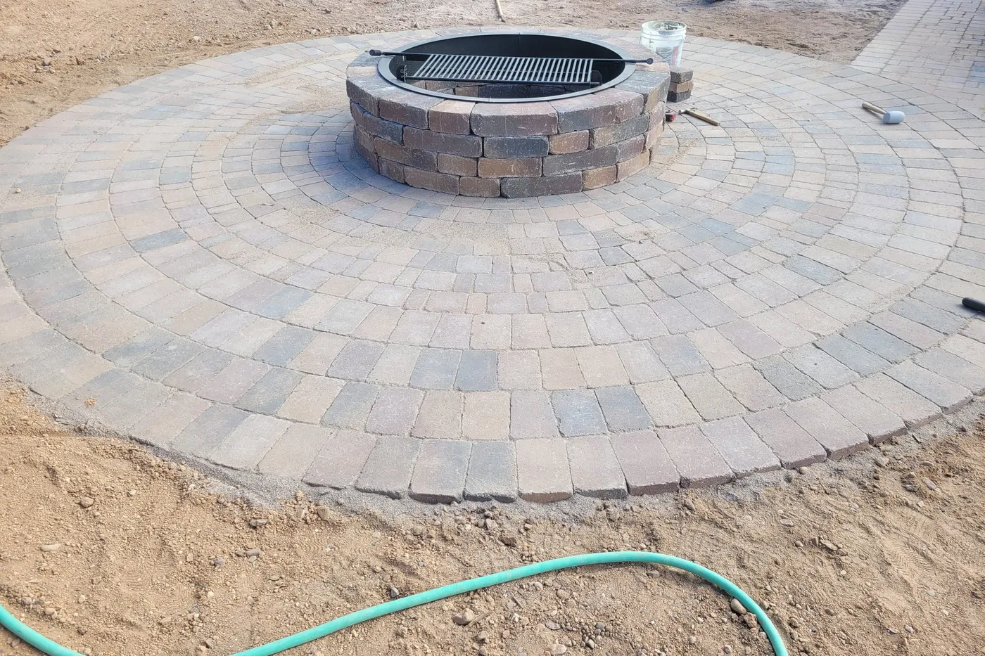 A circular paver fire pit